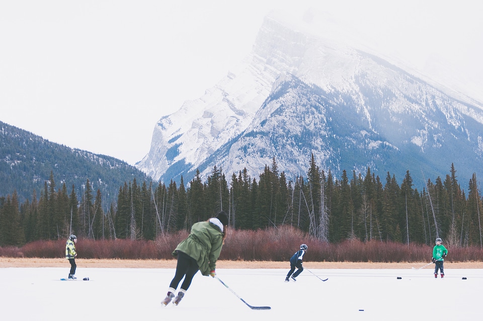 People playing Hockey on frozen lake in Banff National Park, Alberta, Canada