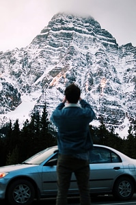 Photographer taking picture of a mountain in Banff National Park, Alberta, Canada