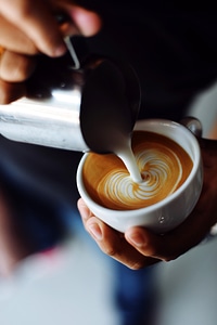 Pouring Coffee and Cream into a Cup photo