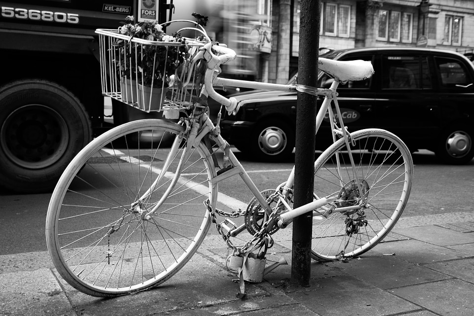 Black and White photo of Bicycle leaning on post