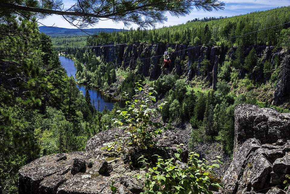 Guy Ziplining down Eagle Canyon, Ontario, Canada
