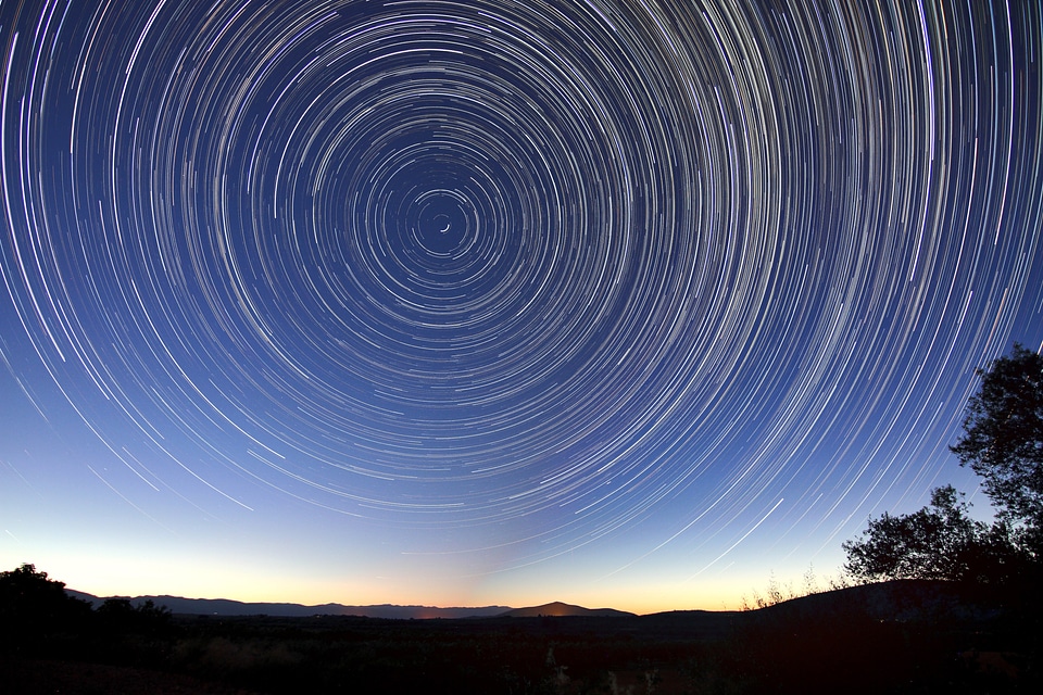 Star Trails in the Sky above the landscape photo