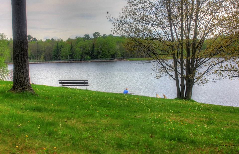Man next to the bench by the lake at Council Grounds State Park, Wisconsin