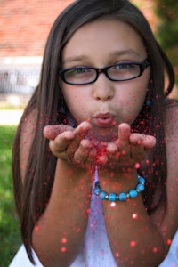 Blowing glitter hands red glitter