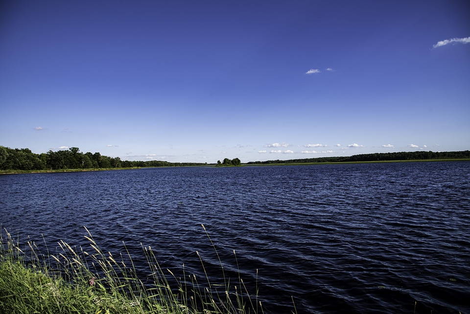 Lake with water under blue sky photo