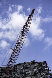 Construction Crane Above Ruins of building photo