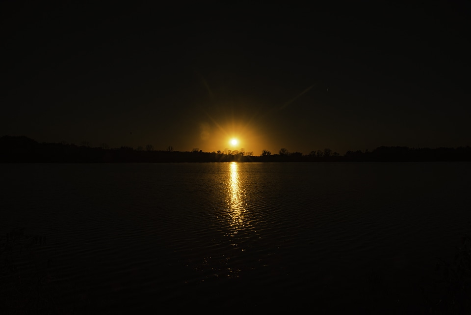 Sunset above the lake with water