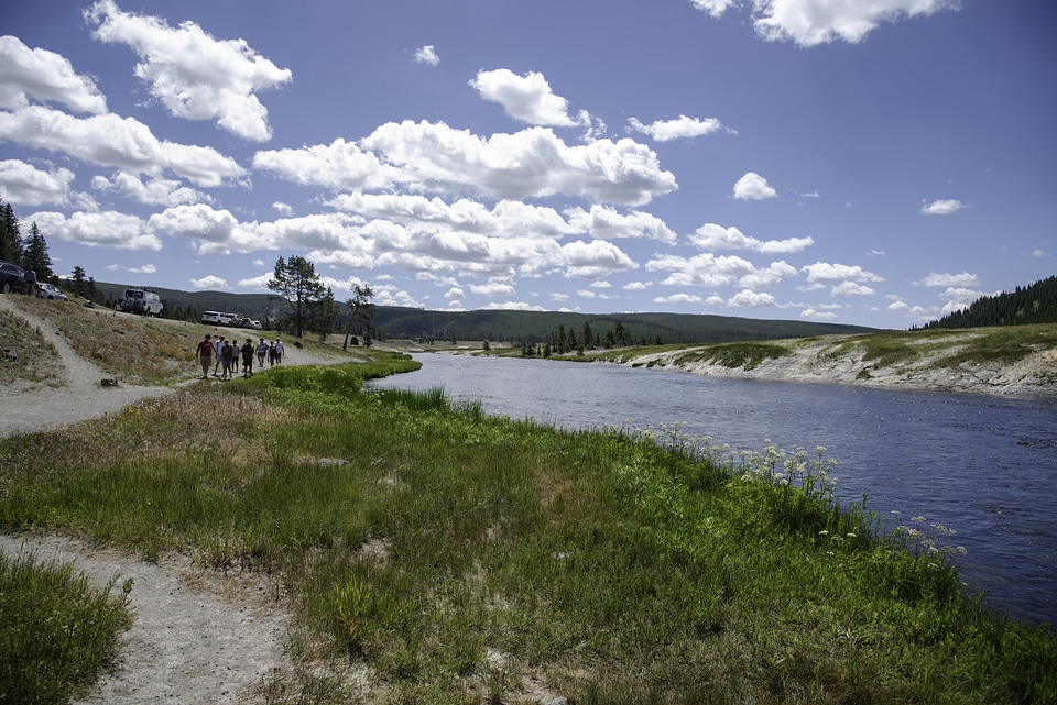 Group of people walking on the path walking in the landscape