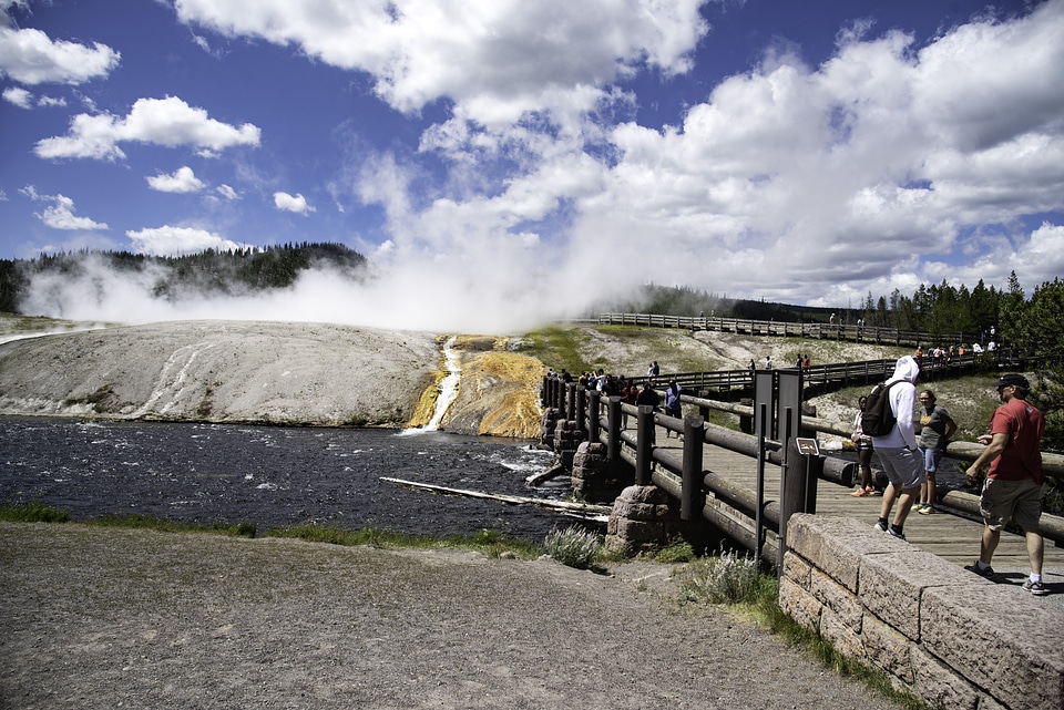 Steam coming from Great Prismatic Spring under the sky and clouds