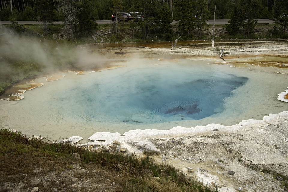 Steam rising from the blue waters of the spring