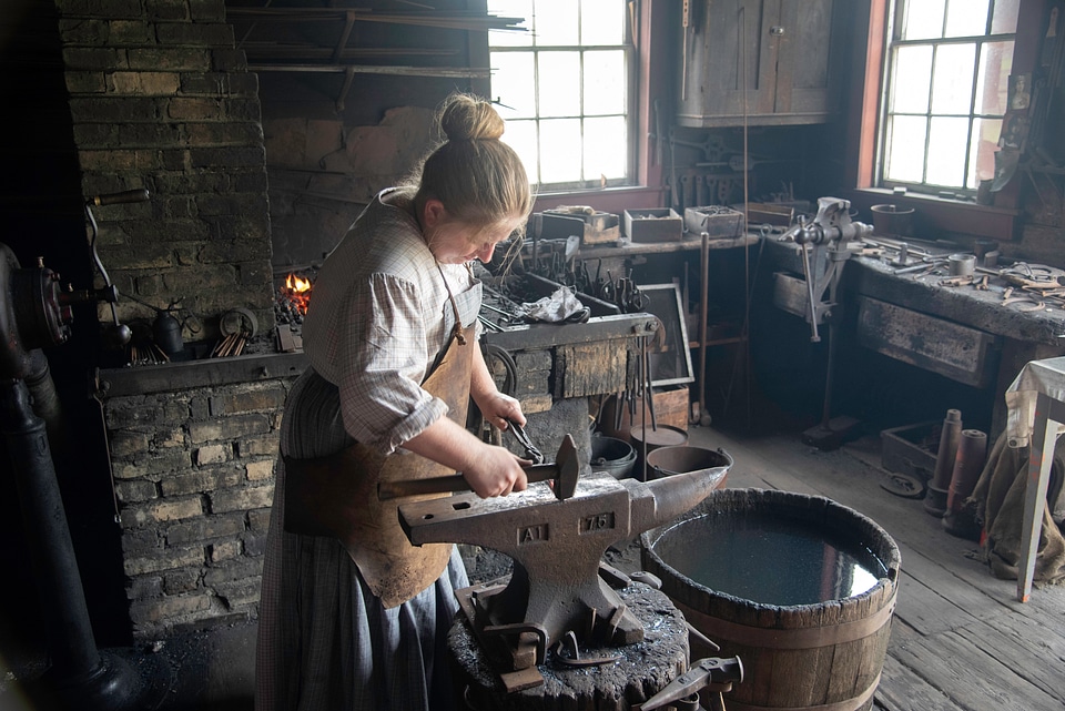 Metalworker hammering on the Anvil