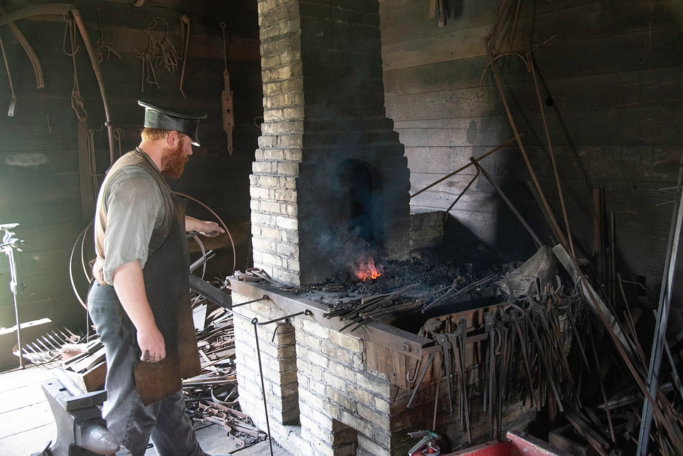 Blacksmith Heating Metal at Anvil