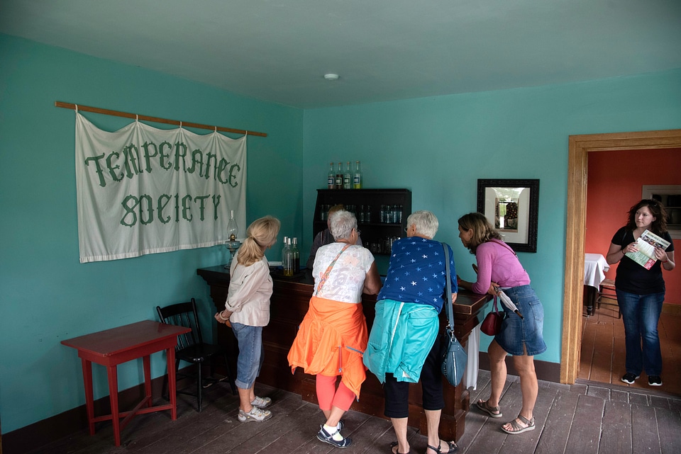 Group of visitors standing at the bar