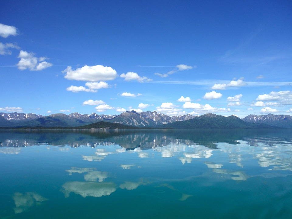 Reflections of mountains and clouds on Lake Clark