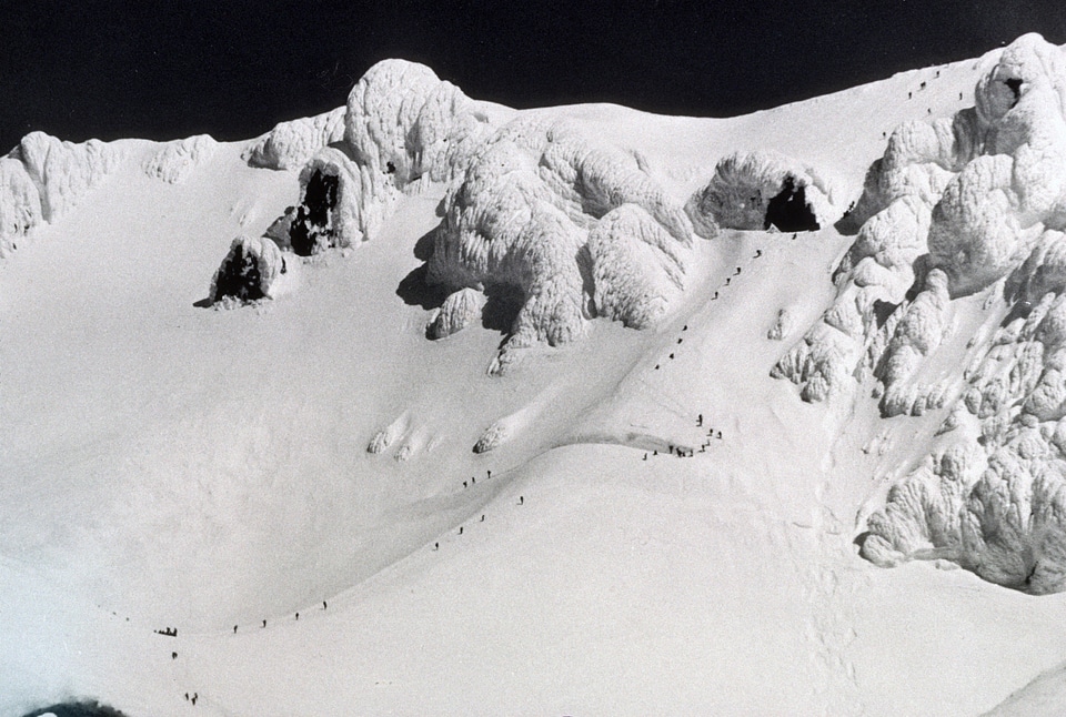 Snow capped peak with climbers on Mount Hood