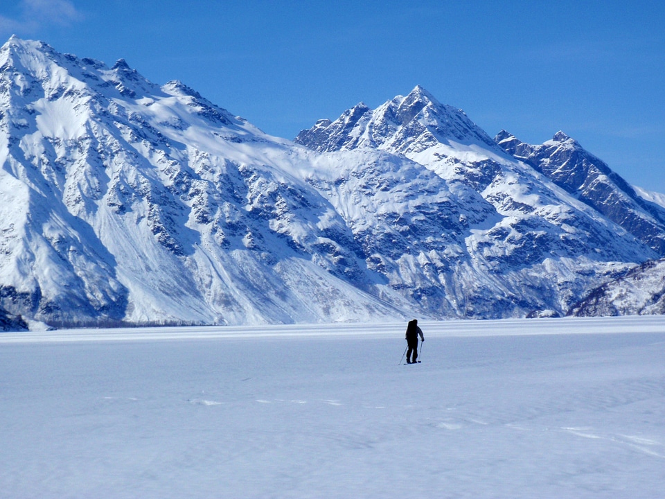 Frozen Crescent Lake landscape with mountains in the background
