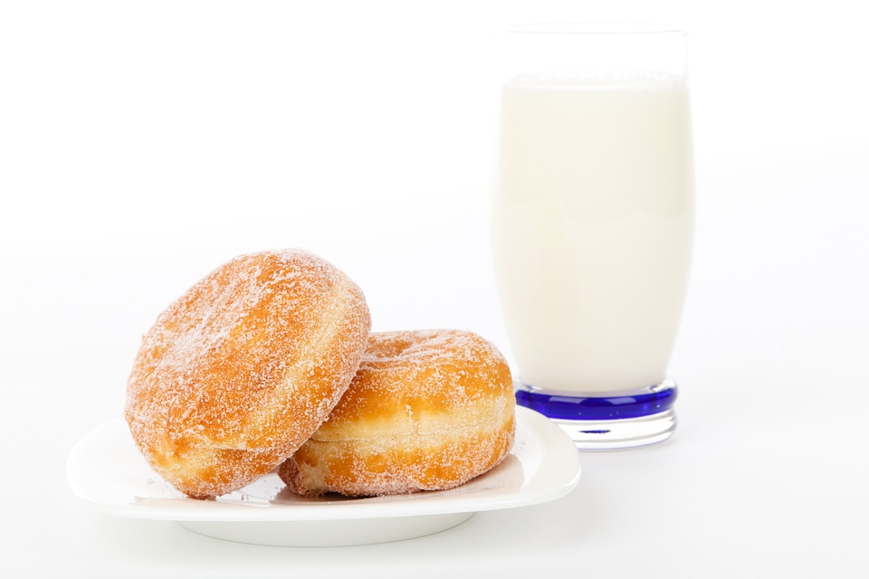 Two Donuts with a glass of Milk