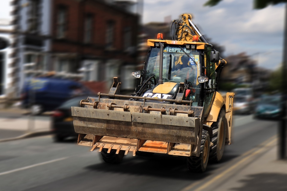 Caterpillar tractor going down the road
