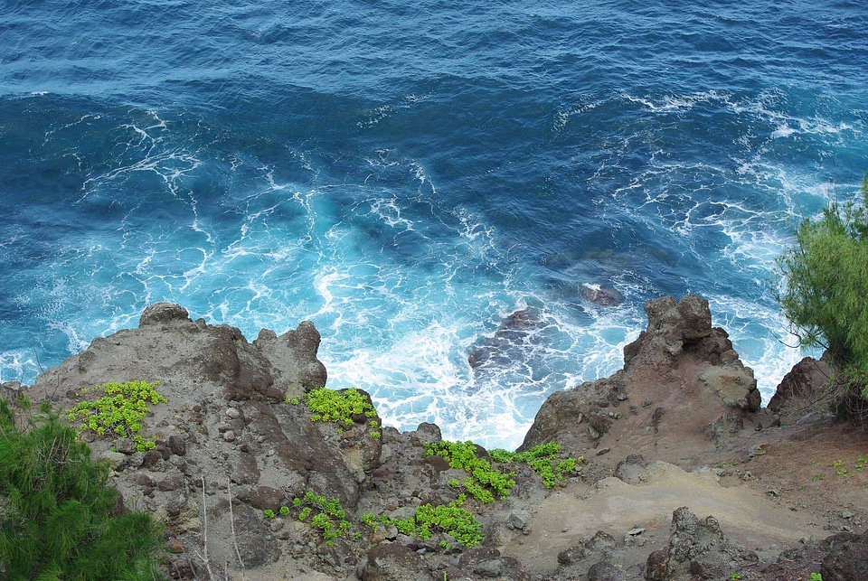 Blue Water Waves Crashing onto rocky shoreline photo
