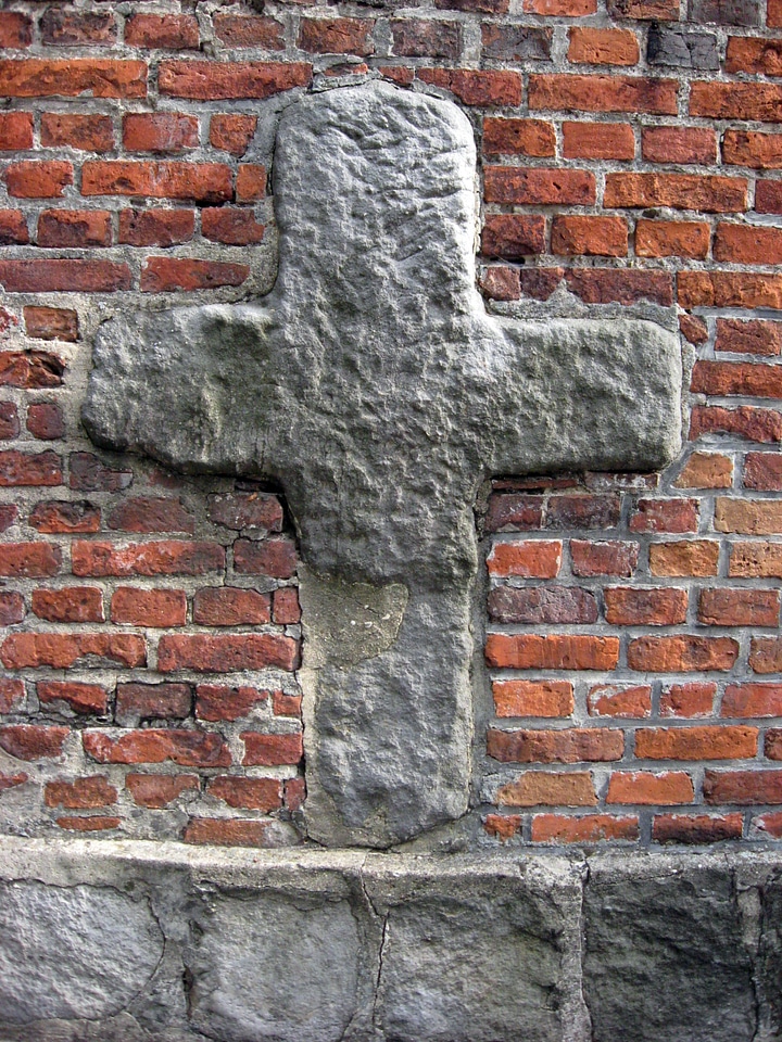 Romanesque cross on the north wall of St. Bartholomew's Church in Konin