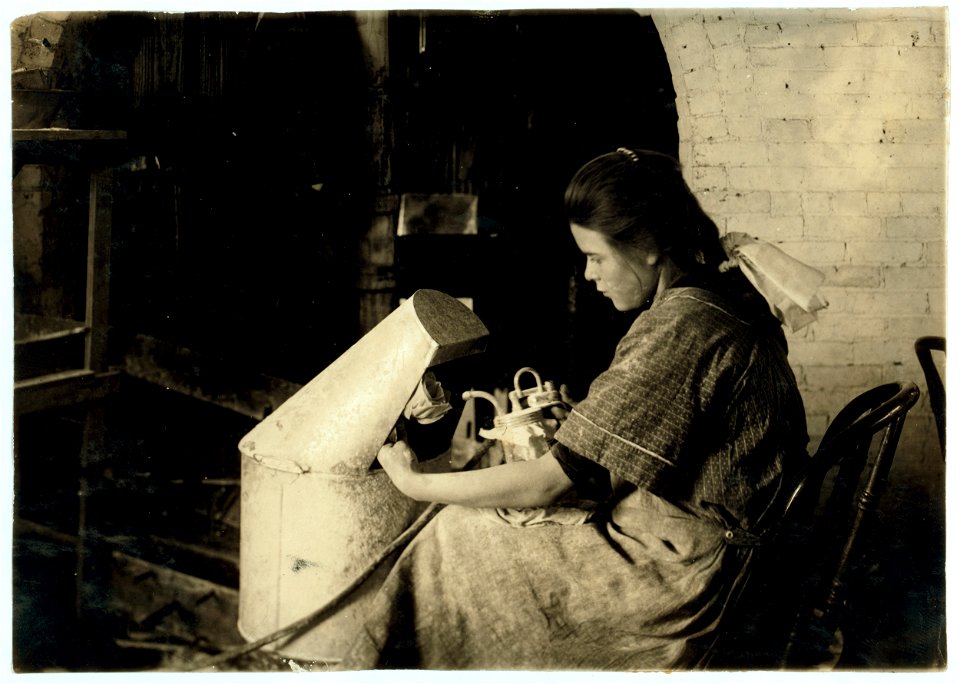 Margaret Reddington, 14 years old, powdering roses with blow pipe at Boston Floral Supply Co., 347-357 Cambridge Street. Said to be the only flower factory in Massachusetts. LOC nclc.05611