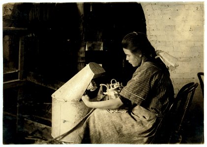 Margaret Reddington, 14 years old, powdering roses with blow pipe at Boston Floral Supply Co., 347-357 Cambridge Street. Said to be the only flower factory in Massachusetts. LOC nclc.05611