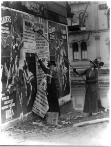 Miss Louise Hall with brush and Miss (i.e. Mrs.) Susan Fitzgerald assisting bill posting in Cincinnati LCCN2001704187