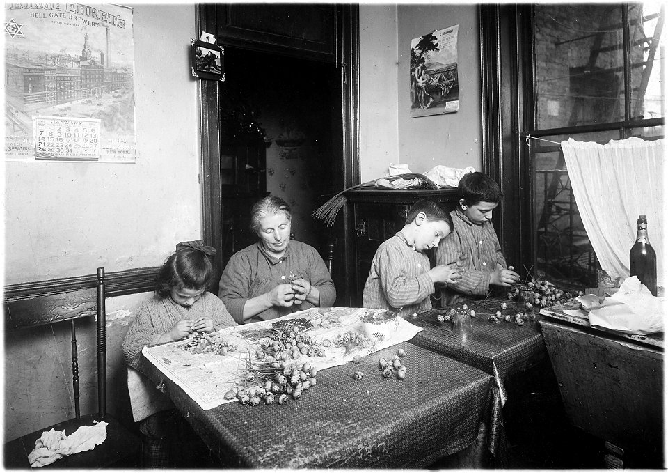 Basso family, making roses in dirty poorly lighted kitchen. Pauline, 6 years old, works after school. Peter, 8, works... - NARA - 523515