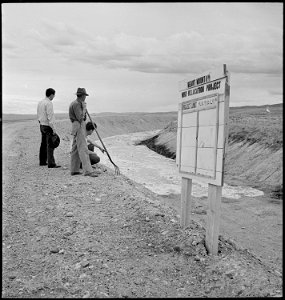 Heart Mountain Relocation Center, Heart Mountain, Wyoming. A group of center residents watch from t . . . - NARA - 539404