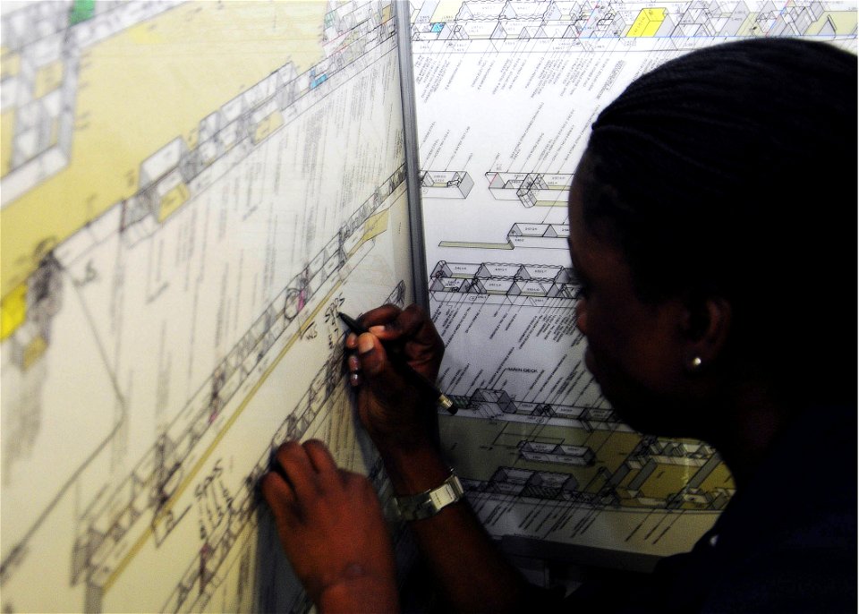 US Navy 090703-N-8607R-005 Aviation Support Equipment Technician Airman Daisy Calliste, attached to Aviation Intermediate Maintenance Department (AIMD), plots shipboard compartments during general quarters onboard USS Bonhomme