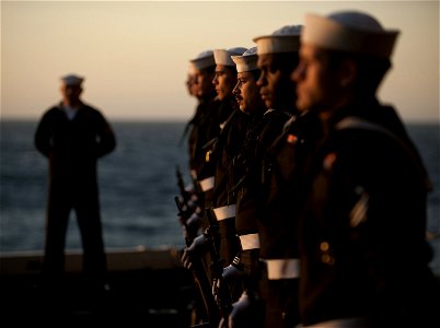 US Navy 111201-N-DR144-193 The rifle detail stands at parade rest during a burial at sea ceremony for 20 former service members aboard the Nimitz-c