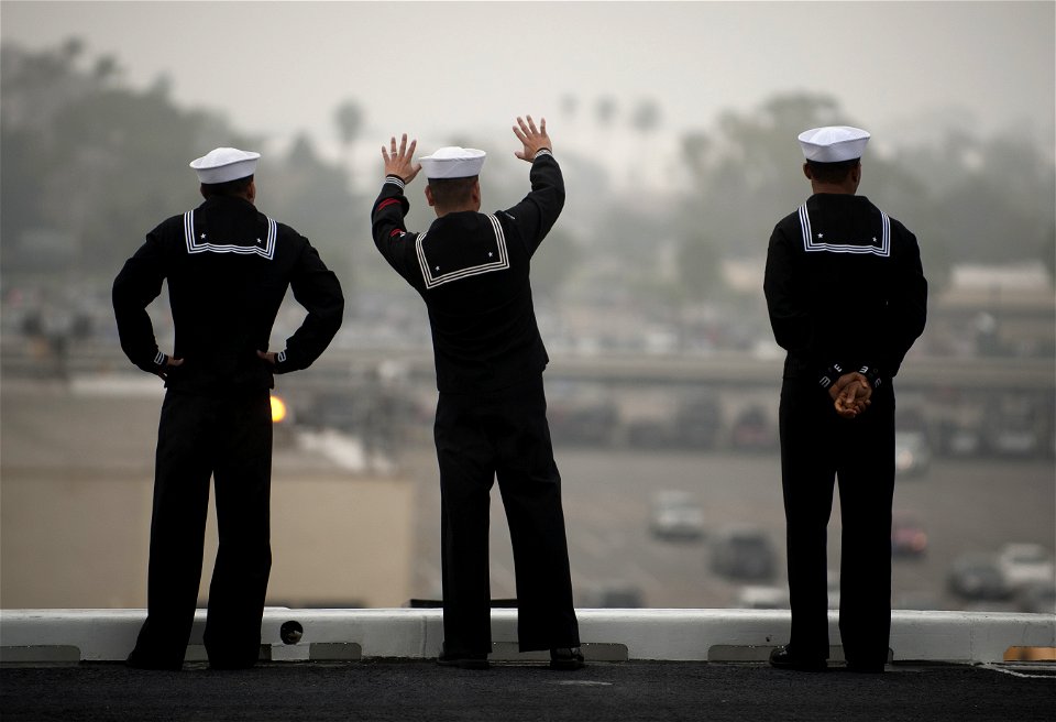 US Navy 111130-N-DR144-447 Sailors wave goodbye to loved ones on the pier while manning the rails as the Nimitz-class aircraft carrier USS Carl Vin