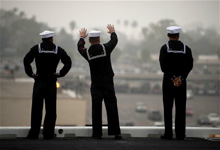 US Navy 111130-N-DR144-447 Sailors wave goodbye to loved ones on the pier while manning the rails as the Nimitz-class aircraft carrier USS Carl Vin