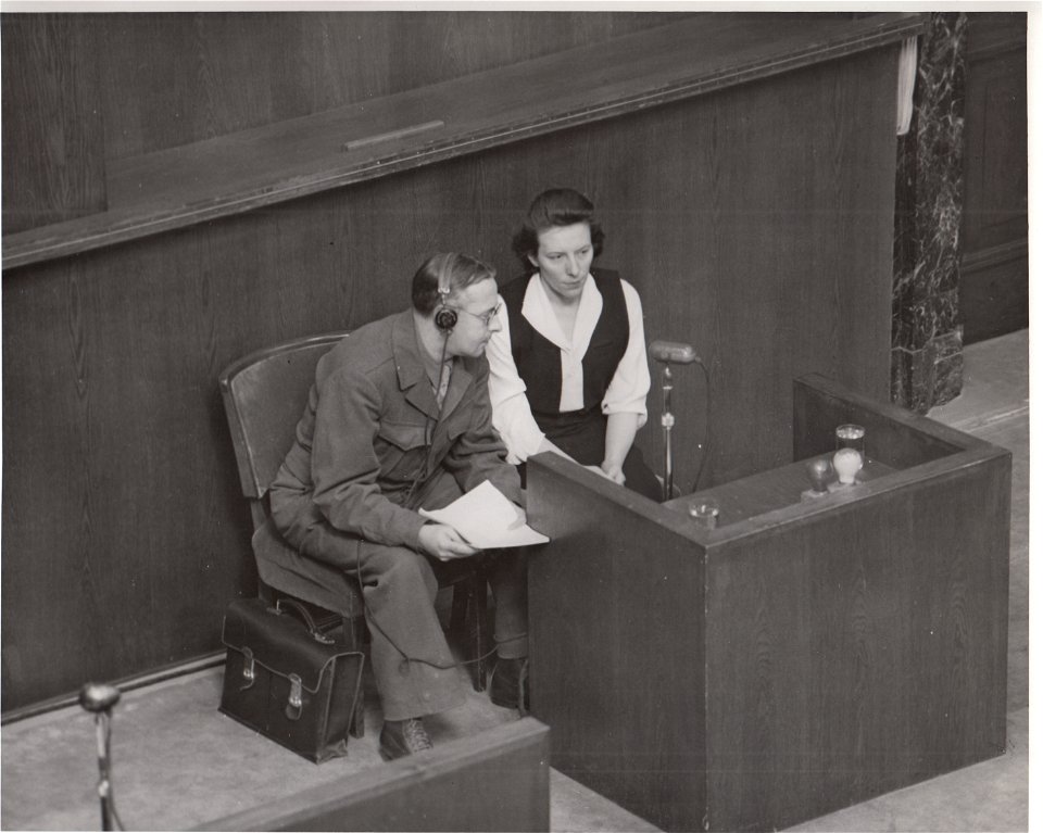 Marie Broel-Plater on witness stand in Doctors' Trial with Polish-English interpreter, Julius Panek