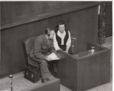 Marie Broel-Plater on witness stand in Doctors' Trial with Polish-English interpreter, Julius Panek