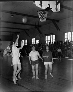 Heart Mountain Relocation Center, Heart Mountain, Wyoming. A hotly contested interscholastic basket . . . - NARA - 539726 photo