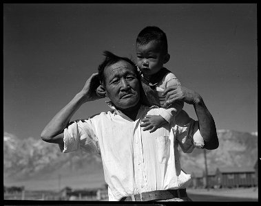 Manzanar Relocation Center, Manzanar, California. Grandfather and grandson of Japanese ancestry at . . . - NARA - 537992 photo