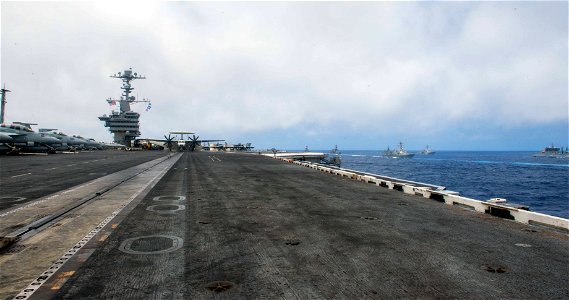 Malabar 2016 participants from the Indian Navy, Japanese Maritime Self-Defense Force (JMSDF), and U.S. Navy sail in formation alongside USS John C. Stennis (CVN 74)
