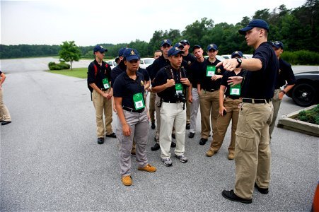 Man points something out to law enforcement explorers photo
