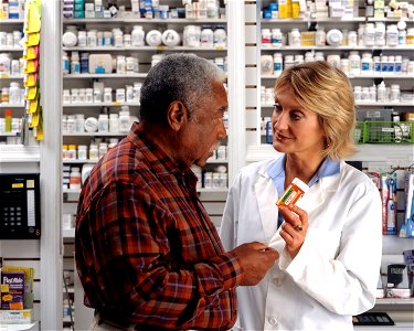 Man consults with pharmacist (2) photo