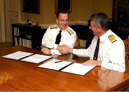 US Navy 061024-N-0696M-001 Chief of Naval Operations (CNO) Adm. Mike Mullen and First Sea Lord of the British Royal Navy, Adm. Sir Jonathon Band sign a letter of understanding for cooperative deployments during an office call a