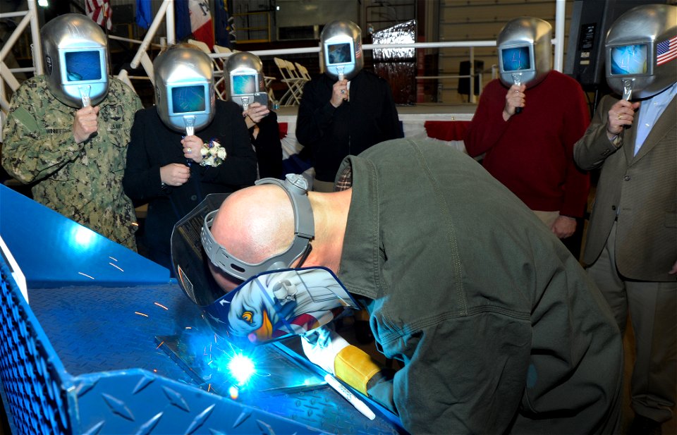 Mary Winnefeld watches as her initials are welded into USS Sioux City. (12662832215)