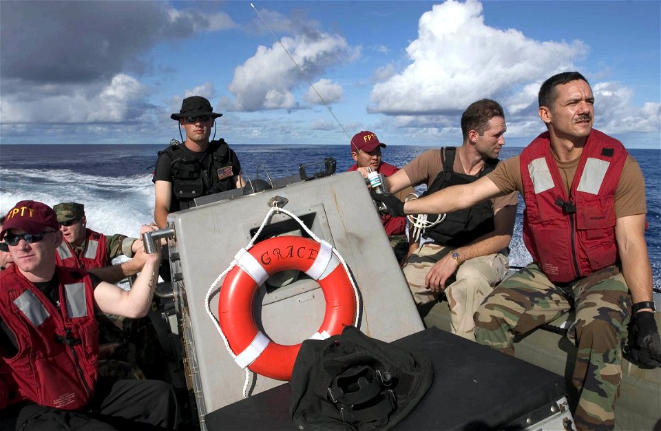 US Navy 060909-N-9851B-001 Boatswain's Mate 2nd Class David Kuefler, assigned to the Arleigh Burke-class guided missile destroyer USS Hopper (DDG 70), transports Hopper's Force Protection Training Team