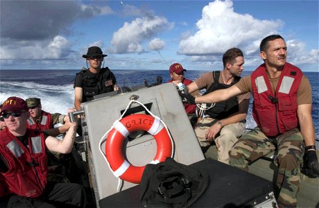 US Navy 060909-N-9851B-001 Boatswain's Mate 2nd Class David Kuefler, assigned to the Arleigh Burke-class guided missile destroyer USS Hopper (DDG 70), transports Hopper's Force Protection Training Team photo