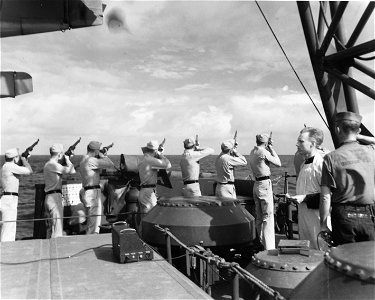 Marines on USS Honolulu (CL-48) fire salute at funeral services for USS Helena (CL-50) Battle of Kula Gulf casualty, July 1943 (80-G-54566)