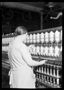 Manchester, New Hampshire - Textiles. Pacific Mills. Spinning frame, Spinner Piecing-up. - NARA - 518747 photo