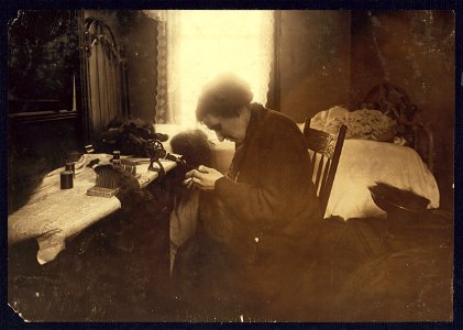 Making hair-goods in a tiny hall-bedroom. Mrs. Chassin, 385 E. 3rd St., N.Y. top floor. The whole tenement is in a most dilapidated and disreputable state. Hair lying on the bed, trunk and LOC nclc.04200 photo
