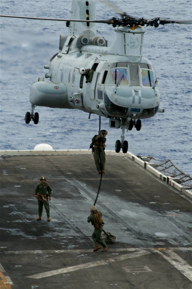 Marines fast rope onto flight deck of USS Peleliu 121005-N-KR526-028