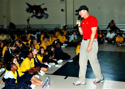 US Navy 061023-N-7427G-001 Greg Poe, an aerobatic pilot in town for the 2006 N'awlins Air Show at Naval Air Station Joint Reserve Base New Orleans, offers anti-drug remarks to local children photo