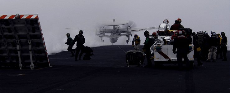 US Navy 090703-N-6538W-013 Sailors prepare the bow catapult for aircraft as an E-2C Hawkeye from the